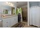 Bathroom with walk-in shower, neutral tile, and a vanity with a beige countertop and mirror at 106 Lanyard Bnd, Peachtree City, GA 30269