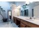 Bathroom boasts double sink vanity, ample lighting, and a serene atrium with a potted tree at 106 Lanyard Bnd, Peachtree City, GA 30269