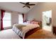 This spacious bedroom features plush carpet, a ceiling fan, and bright natural lighting from two windows at 106 Lanyard Bnd, Peachtree City, GA 30269