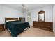 Spacious bedroom featuring carpet, ceiling fan, double dresser, and ample natural light at 106 Lanyard Bnd, Peachtree City, GA 30269