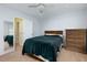 Bright bedroom featuring carpet, bed, and a mirror and dresser at 106 Lanyard Bnd, Peachtree City, GA 30269