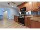 Bright kitchen features wood cabinets, stainless steel stove and microwave, and granite countertops at 106 Lanyard Bnd, Peachtree City, GA 30269