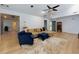 Open-concept living room featuring stylish furnishings and seamless flow to other living spaces at 106 Lanyard Bnd, Peachtree City, GA 30269