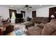 Spacious living room with comfortable seating, large rug, and modern entertainment center at 106 Lanyard Bnd, Peachtree City, GA 30269