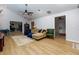 Bright living room boasts open floor plan, laminate floors, and modern ceiling fan at 106 Lanyard Bnd, Peachtree City, GA 30269