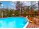 Sparkling pool with surrounding deck and fenced backyard, ideal for Gathering fun and privacy at 106 Lanyard Bnd, Peachtree City, GA 30269