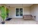 Inviting covered porch featuring a swing and a potted plant, perfect for relaxing at 106 Lanyard Bnd, Peachtree City, GA 30269