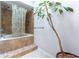 The tiled shower features a shower-tub combination and an eye-catching decorative potted plant at 106 Lanyard Bnd, Peachtree City, GA 30269