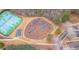 Aerial view of community playground next to tennis courts and walking path in wooded area at 108 Rex Ave, Canton, GA 30114
