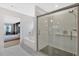 Bright, contemporary bathroom featuring a glass shower with large bathtub next to the bedroom entrance at 108 Rex Ave, Canton, GA 30114