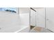 Bright bathroom featuring a luxurious soaking tub, glass-enclosed shower, and modern white tiling at 108 Rex Ave, Canton, GA 30114