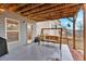 Relaxing covered patio with a wooden swing, string lights, and access to a well-maintained backyard at 108 Rex Ave, Canton, GA 30114