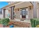 Inviting front porch with brick facade, decorative columns, and seating area at 108 Rex Ave, Canton, GA 30114