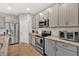 Well-lit kitchen has stainless steel appliances, plenty of cabinet space, and granite countertops at 108 Rex Ave, Canton, GA 30114
