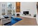 Bright living room featuring a fireplace, large windows, and hardwood floors at 108 Rex Ave, Canton, GA 30114