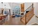 Open-concept living room with a fireplace, large windows, and staircase access, seamlessly connecting living spaces at 108 Rex Ave, Canton, GA 30114