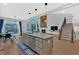 Bright living room featuring kitchen island, staircase, fireplace, and large windows at 108 Rex Ave, Canton, GA 30114