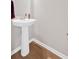 Powder room featuring a pedestal sink with modern fixtures, and clean finishes at 108 Rex Ave, Canton, GA 30114