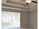 Bedroom featuring tray ceilings and neutral color palette at 680 Mason Grove Pkwy, Lawrenceville, GA 30043