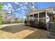 View of the backyard with a screened porch and a lush lawn surrounded by greenery at 541 Hickory Sw Dr, Marietta, GA 30064