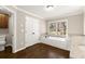 Bathroom with hardwood floors, separate soaking tub, and a doorway leading to a toilet room at 541 Hickory Sw Dr, Marietta, GA 30064