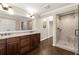 Bathroom with double vanity, large mirror, and frameless glass shower, offering a clean and modern design at 541 Hickory Sw Dr, Marietta, GA 30064