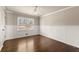 Bright bedroom with wood floors, ceiling fan, and natural light from the window at 541 Hickory Sw Dr, Marietta, GA 30064