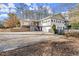 Charming two-story home with a well-maintained yard, front porch, and ample parking in a gravel driveway at 541 Hickory Sw Dr, Marietta, GA 30064