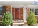 A charming red-brick home with a red front door, complemented by manicured bushes at 541 Hickory Sw Dr, Marietta, GA 30064