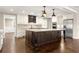 Modern kitchen with white cabinets, stainless steel appliances, a large island, and sleek pendant lighting at 541 Hickory Sw Dr, Marietta, GA 30064