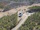 An aerial view showcases the new construction home, set amidst a lush forest and a long, winding driveway at 847 Cumberland Ave, Dallas, GA 30157