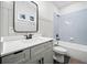 Elegant bathroom with white vanity, black hardware, and a combination shower and tub at 847 Cumberland Ave, Dallas, GA 30157