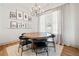 Cozy dining room with wood floors, a round table, black chairs, and decorative wall shelving at 847 Cumberland Ave, Dallas, GA 30157