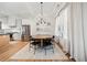 Bright dining area featuring a round wooden table, modern black chairs, and sheer white curtains at 847 Cumberland Ave, Dallas, GA 30157