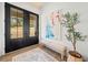 Bright foyer with a double-door entry, wood floors, a modern art piece, and a cozy bench at 847 Cumberland Ave, Dallas, GA 30157