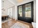 Elegant entry way featuring wood flooring and a double glass door that offers serene view at 847 Cumberland Ave, Dallas, GA 30157