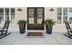 Inviting front porch featuring black rocking chairs, potted ferns, and a stylish 'Welcome' doormat at 847 Cumberland Ave, Dallas, GA 30157