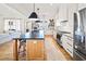 Bright open kitchen featuring an island with seating, stainless appliances, and a farmhouse sink at 847 Cumberland Ave, Dallas, GA 30157