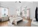 Bright main bedroom featuring large windows, neutral decor, and wood flooring at 847 Cumberland Ave, Dallas, GA 30157