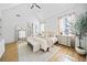 Airy main bedroom with neutral colors, wood floors, and a view into the bathroom at 847 Cumberland Ave, Dallas, GA 30157