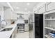 Well-lit kitchen featuring stainless steel appliances, light countertops, and white cabinets at 136 Peachtree Memorial Nw Dr # Sc-4, Atlanta, GA 30309