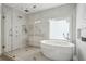 Modern bathroom featuring a standalone tub and a glass-enclosed shower at 1377 Village Park Ne Dr, Brookhaven, GA 30319