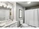 Clean bathroom featuring a marble countertop, updated fixtures, and shower with curtain at 1377 Village Park Ne Dr, Brookhaven, GA 30319
