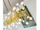Close up of a modern gold light fixture with spherical glass shades at 1377 Village Park Ne Dr, Brookhaven, GA 30319