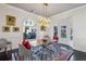 Bright dining room with wooden table and modern chairs, and decorative chandelier at 1377 Village Park Ne Dr, Brookhaven, GA 30319