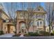 Stunning two-story home with a brick facade, arched entryway, and attached carport at 1377 Village Park Ne Dr, Brookhaven, GA 30319