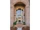 Elegant front door with brick surround, transom window, and decorative wreath at 1377 Village Park Ne Dr, Brookhaven, GA 30319