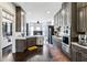 Modern kitchen with stainless steel appliances, grey cabinets, and hardwood floors at 1377 Village Park Ne Dr, Brookhaven, GA 30319