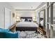 Cozy main bedroom featuring a king bed, large mirror, and hardwood floors at 1377 Village Park Ne Dr, Brookhaven, GA 30319