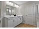 Modern bathroom featuring a double vanity, wood look flooring, and white cabinetry at 280 Rockledge Sw Bnd, Powder Springs, GA 30127